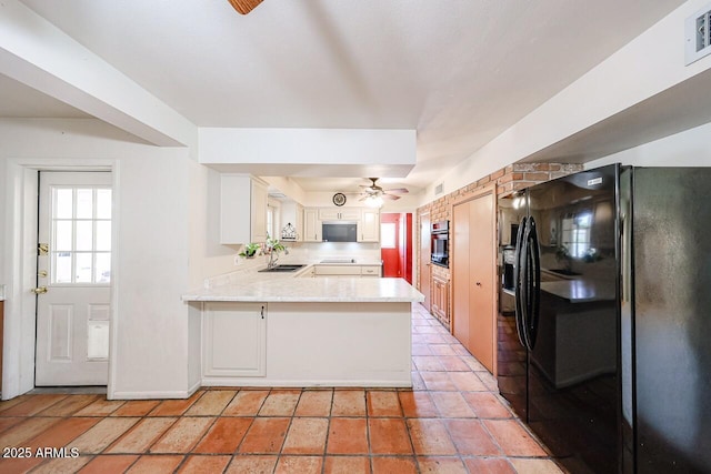 519 N Redondo Dr N, Litchfield Park, AZ 85340 - kitchen with stainless steel appliances, a peninsula, a ceiling fan, and white cabinetry
