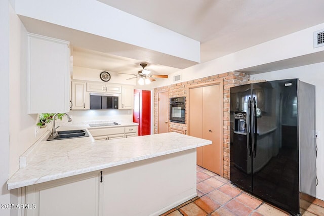 519 N Redondo Dr N, Litchfield Park, AZ 85340 - kitchen with black appliances, a peninsula, ceiling fan, and white cabinetry