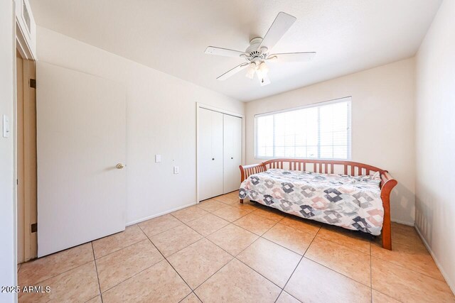 519 N Redondo Dr N, Litchfield Park, AZ 85340 - bedroom featuring light tile patterned floors, a closet, and a ceiling fan