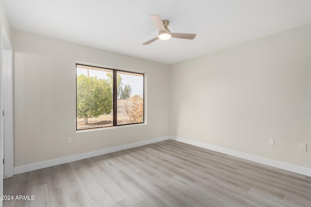 spare room featuring ceiling fan and light hardwood / wood-style flooring