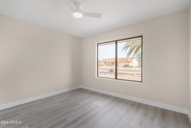 spare room featuring ceiling fan and light hardwood / wood-style floors