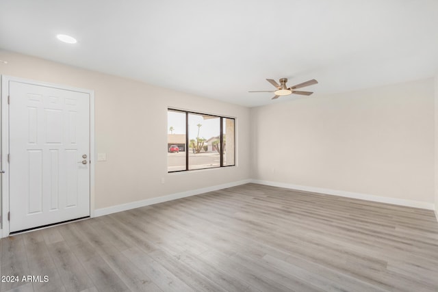 spare room with light hardwood / wood-style flooring and ceiling fan