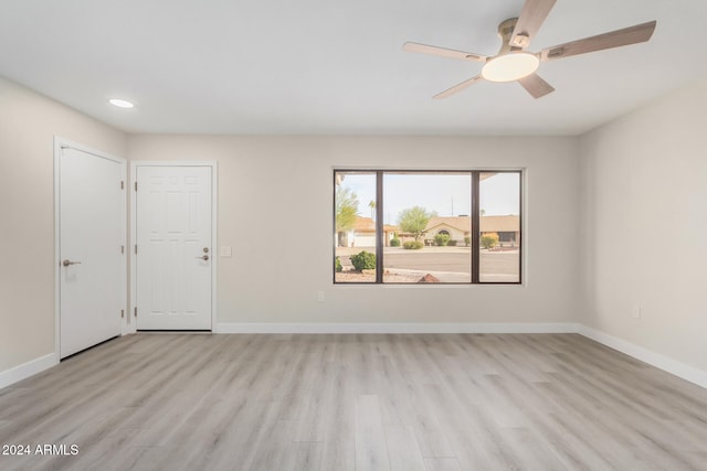 spare room with ceiling fan and light hardwood / wood-style floors