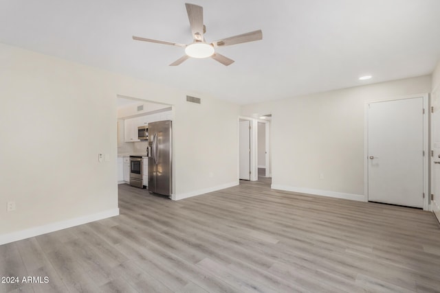 unfurnished living room featuring ceiling fan and light hardwood / wood-style floors