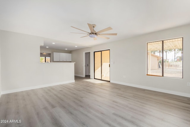 unfurnished living room with ceiling fan, a healthy amount of sunlight, and light hardwood / wood-style floors