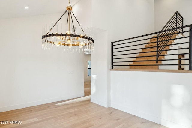 unfurnished dining area featuring hardwood / wood-style floors and an inviting chandelier