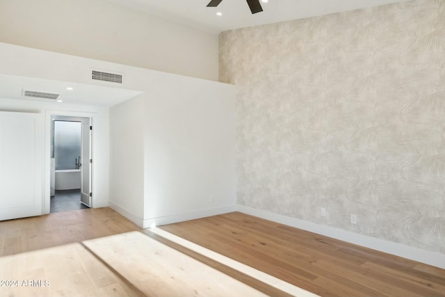 empty room featuring hardwood / wood-style flooring and ceiling fan