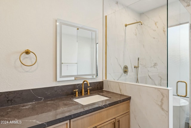 bathroom featuring vanity and a shower with door