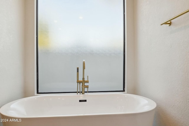 bathroom with a tub to relax in