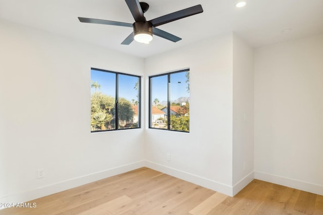 empty room with light wood-type flooring and ceiling fan