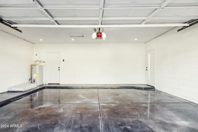 garage featuring a garage door opener and water heater