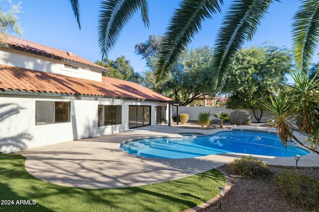 view of swimming pool featuring a patio area and an in ground hot tub