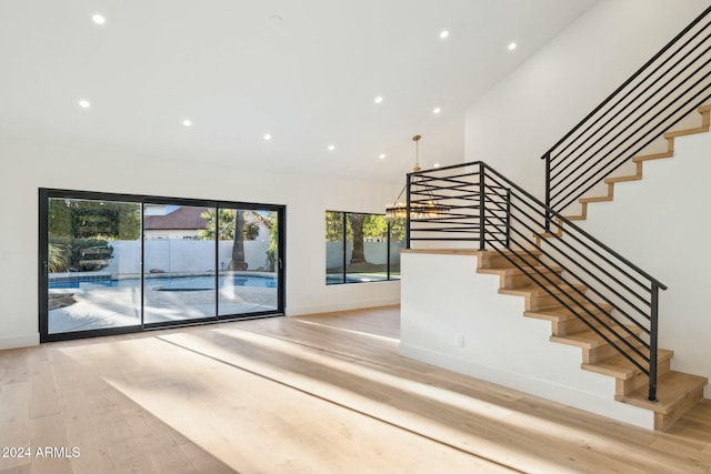 stairs featuring wood-type flooring and lofted ceiling