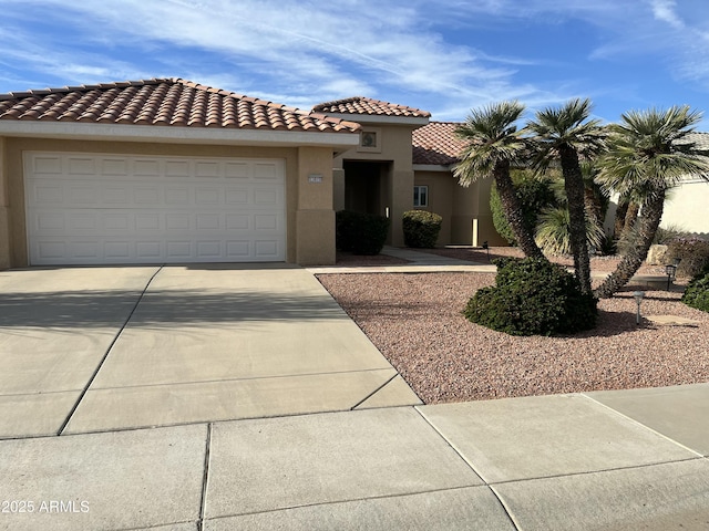 mediterranean / spanish-style home with a garage