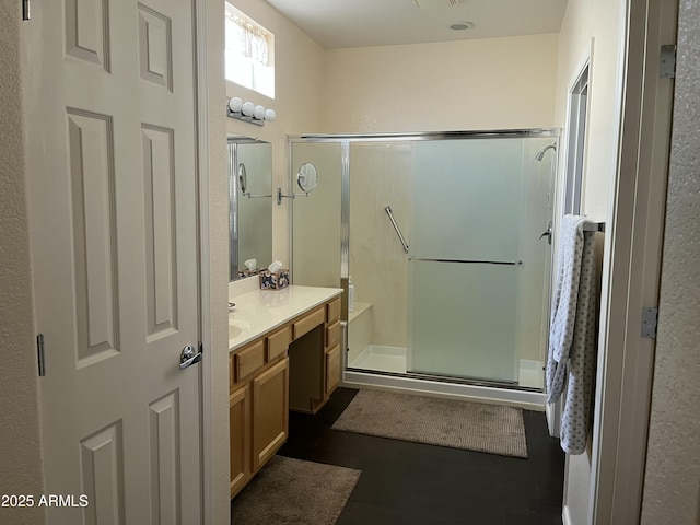 bathroom with vanity and a shower with shower door