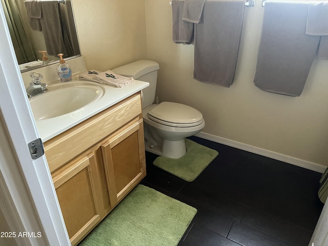 bathroom featuring vanity, toilet, and tile patterned flooring