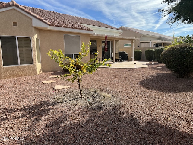 rear view of property with a patio and a pergola