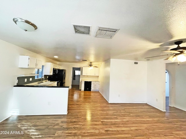 kitchen with kitchen peninsula, white cabinetry, and light wood-type flooring