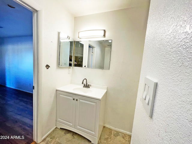 bathroom with vanity and hardwood / wood-style flooring