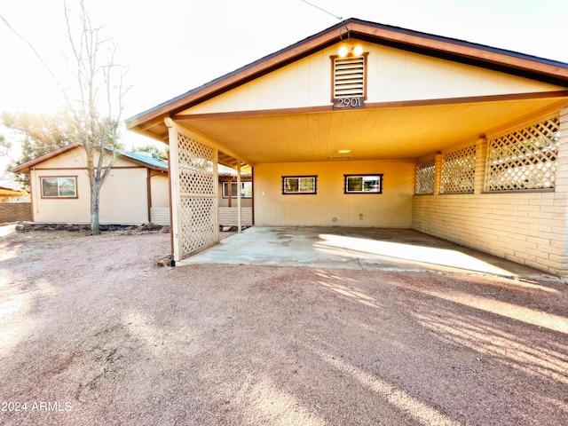 rear view of property with a carport