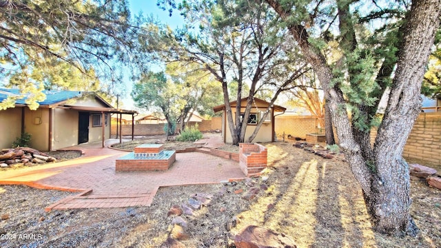 view of yard with a patio and a storage shed