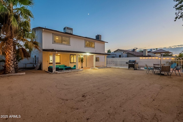 6216 W Poinsettia Dr, Glendale, AZ 85304 - back of property at dusk with a chimney, a patio, a fenced backyard, an outdoor hangout area, and central AC