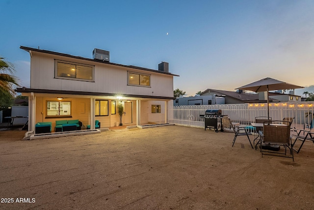 6216 W Poinsettia Dr, Glendale, AZ 85304 - back of house at dusk with fence, central AC, a chimney, and a patio area