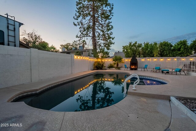 6216 W Poinsettia Dr, Glendale, AZ 85304 - pool at dusk featuring a patio and a fenced backyard
