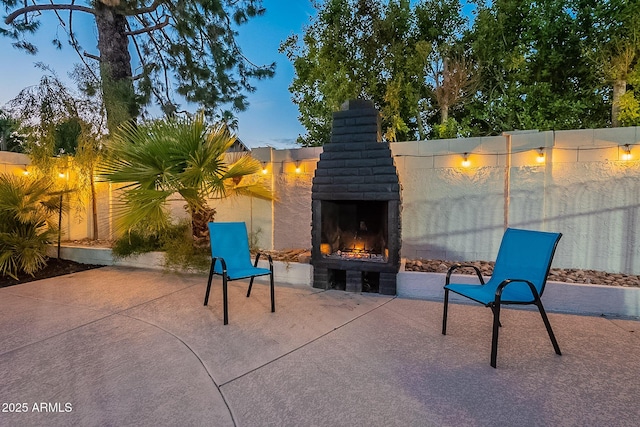 6216 W Poinsettia Dr, Glendale, AZ 85304 - view of patio with a warm lit fireplace and fence