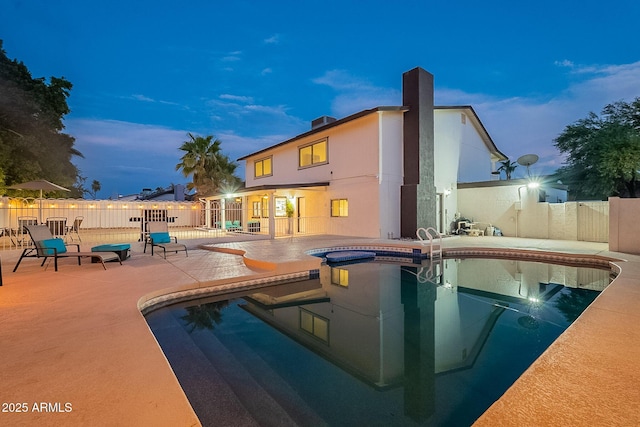 6216 W Poinsettia Dr, Glendale, AZ 85304 - pool at dusk with a patio, fence, and a jacuzzi