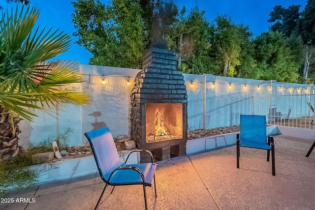 6216 W Poinsettia Dr, Glendale, AZ 85304 - view of patio / terrace with a lit fireplace