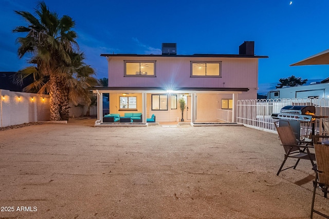 6216 W Poinsettia Dr, Glendale, AZ 85304 - back of house at twilight with fence, a porch, a chimney, and central AC unit