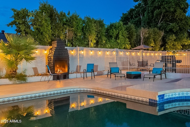 6216 W Poinsettia Dr, Glendale, AZ 85304 - view of swimming pool with a patio area, a warm lit fireplace, and fence