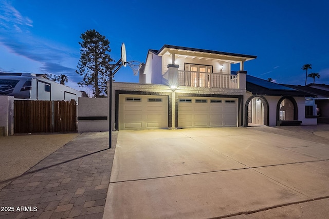 6216 W Poinsettia Dr, Glendale, AZ 85304 - view of front facade with a balcony, an attached garage, driveway, fence, and stucco siding