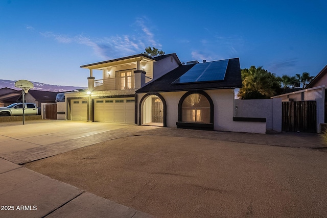 6216 W Poinsettia Dr, Glendale, AZ 85304 - traditional-style house featuring a balcony, solar panels, driveway, and fence