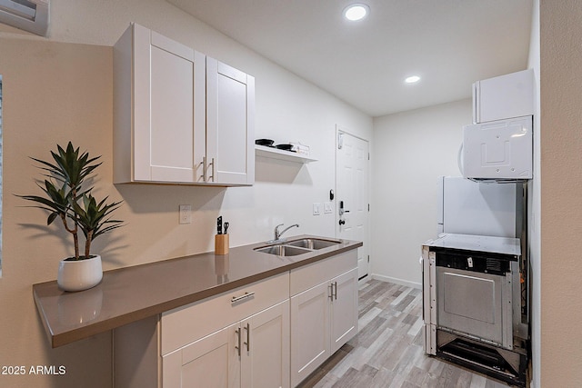 6216 W Poinsettia Dr, Glendale, AZ 85304 - kitchen featuring a sink, open shelves, light wood-style floors, recessed lighting, and white cabinets