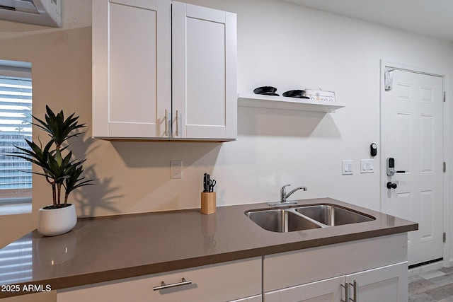 6216 W Poinsettia Dr, Glendale, AZ 85304 - kitchen with dark countertops, a sink, and white cabinetry