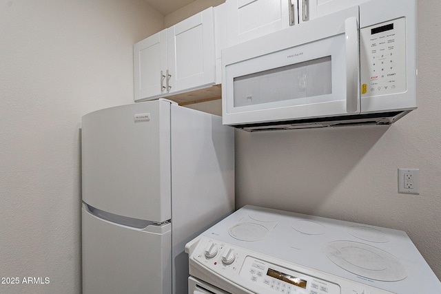6216 W Poinsettia Dr, Glendale, AZ 85304 - kitchen with white appliances, white cabinetry, and washer / dryer