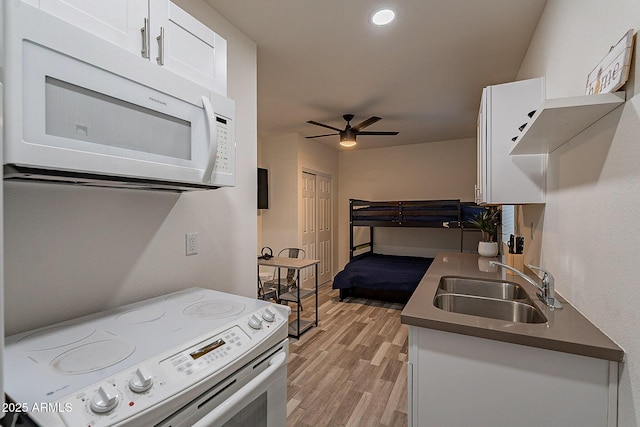 6216 W Poinsettia Dr, Glendale, AZ 85304 - kitchen with white appliances, a sink, ceiling fan, light wood finished floors, and white cabinetry