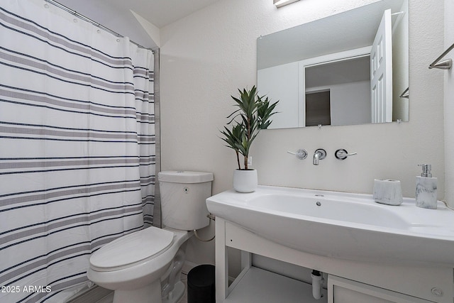 6216 W Poinsettia Dr, Glendale, AZ 85304 - bathroom featuring toilet, a shower with curtain, vanity, and a textured wall