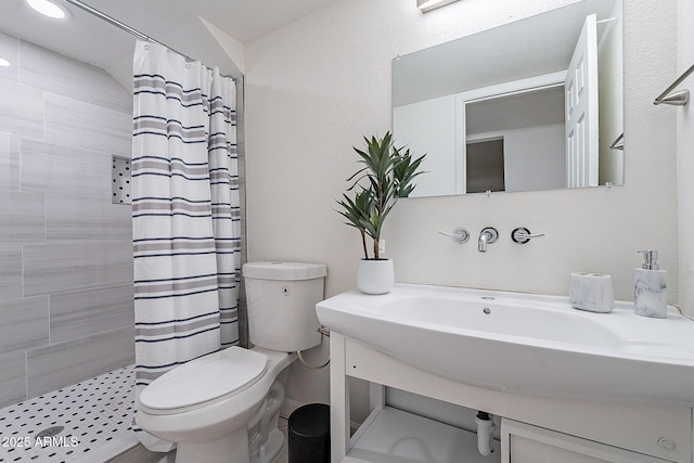 6216 W Poinsettia Dr, Glendale, AZ 85304 - bathroom featuring a tile shower, toilet, and vanity