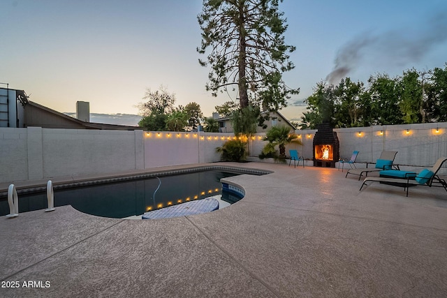 6216 W Poinsettia Dr, Glendale, AZ 85304 - pool at dusk with a patio area and a fenced backyard