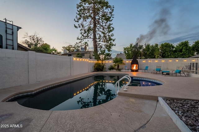 6216 W Poinsettia Dr, Glendale, AZ 85304 - pool at dusk featuring a patio area and a fenced backyard
