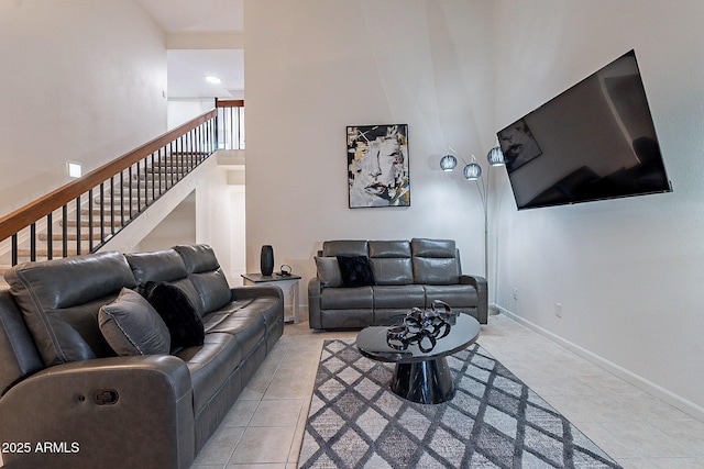 6216 W Poinsettia Dr, Glendale, AZ 85304 - living room with light tile patterned floors, a towering ceiling, stairs, and baseboards