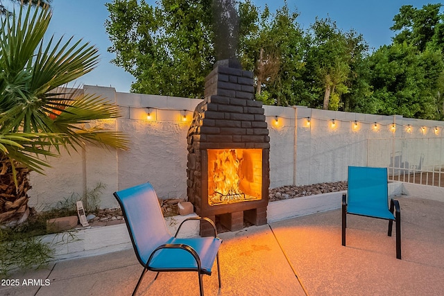 6216 W Poinsettia Dr, Glendale, AZ 85304 - view of patio / terrace featuring a lit fireplace