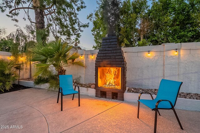 6216 W Poinsettia Dr, Glendale, AZ 85304 - view of patio featuring an outdoor fireplace and a fenced backyard