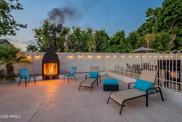 6216 W Poinsettia Dr, Glendale, AZ 85304 - view of patio / terrace featuring a lit fireplace and fence