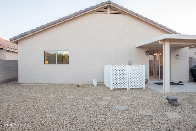 back of property with a patio