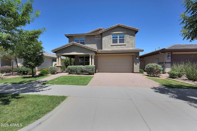 9750 E Radioactive Dr, Mesa, AZ 85212 - view of front facade featuring decorative driveway, a garage, stucco siding, and a front lawn