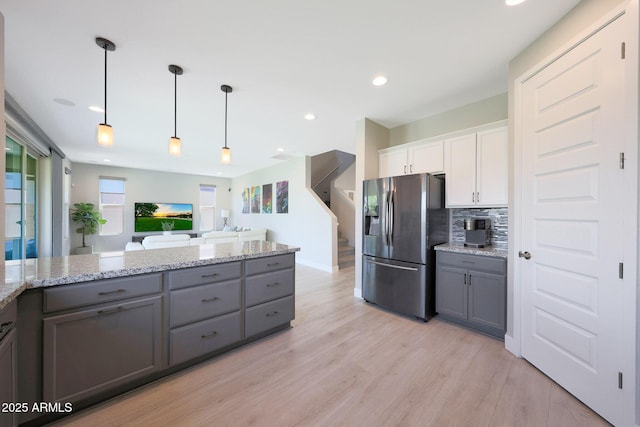 9750 E Radioactive Dr, Mesa, AZ 85212 - kitchen with stainless steel fridge with ice dispenser, gray cabinets, light wood-style flooring, white cabinetry, and decorative backsplash